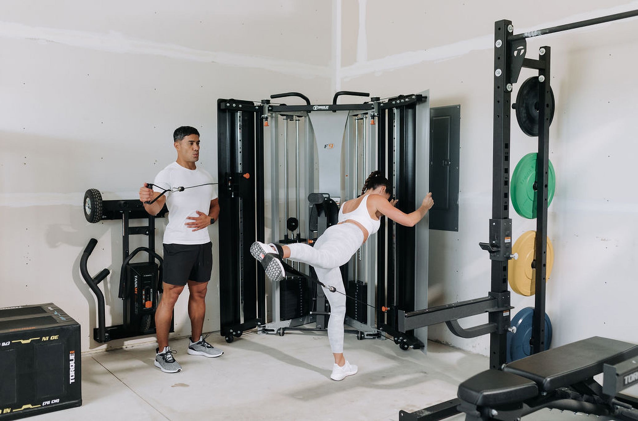 Man and Woman Using F9 Functional Trainer Accessories