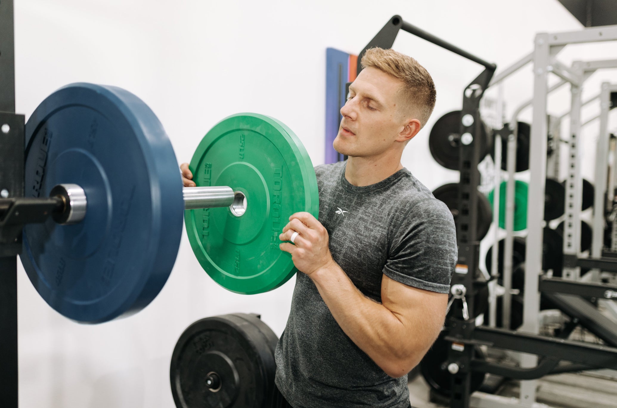 Brent Fikowski Holding Green Torque Bumper Plate
