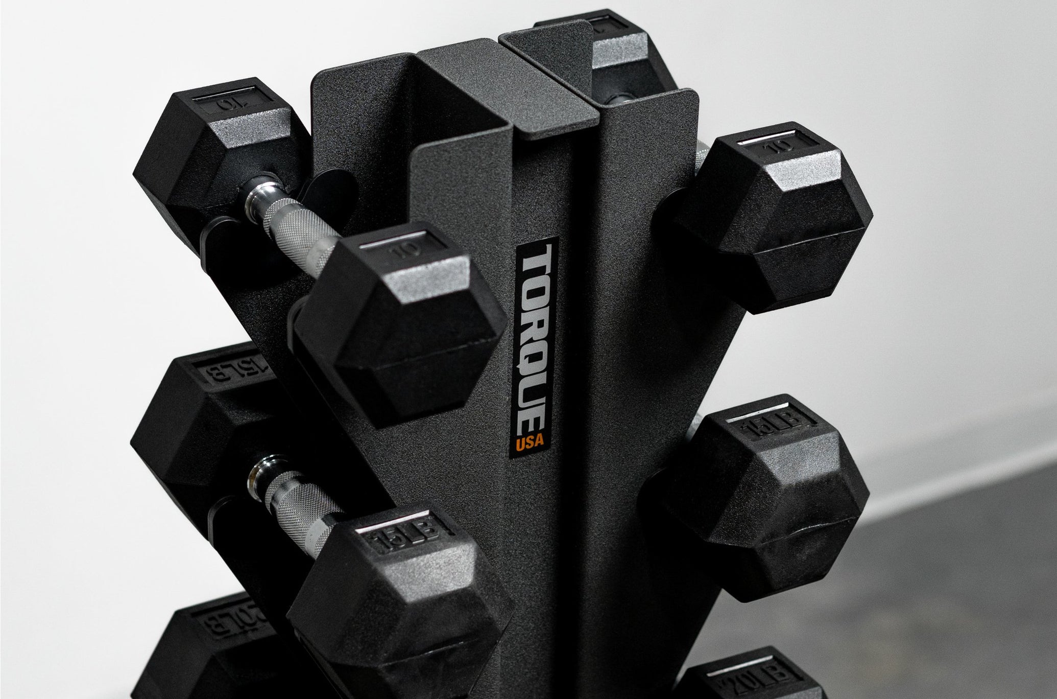 Close Up Of Dumbbells On Vertical Dumbbell Rack <black>