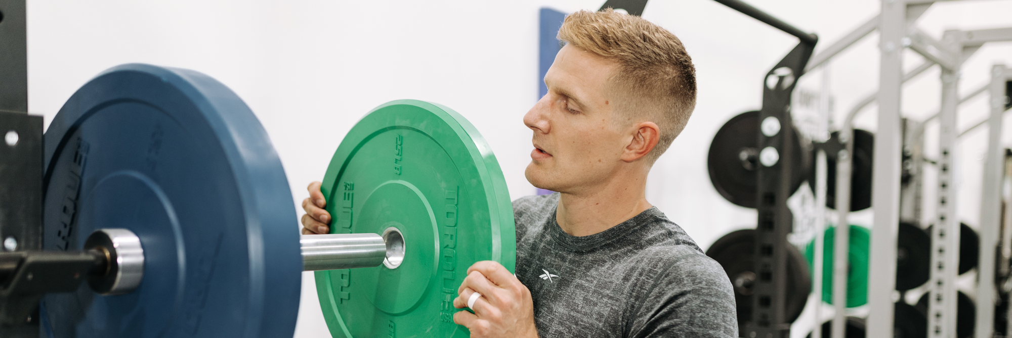 Brent Fikowski Loading Weight Plates Onto Barbell